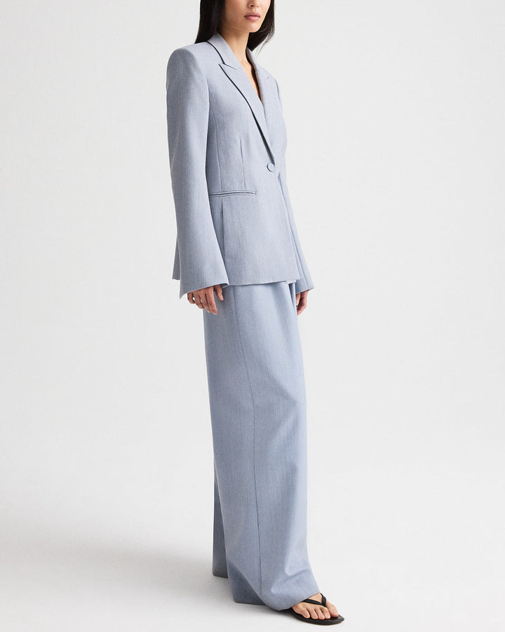 Woman wearing a light blue suit on a white background